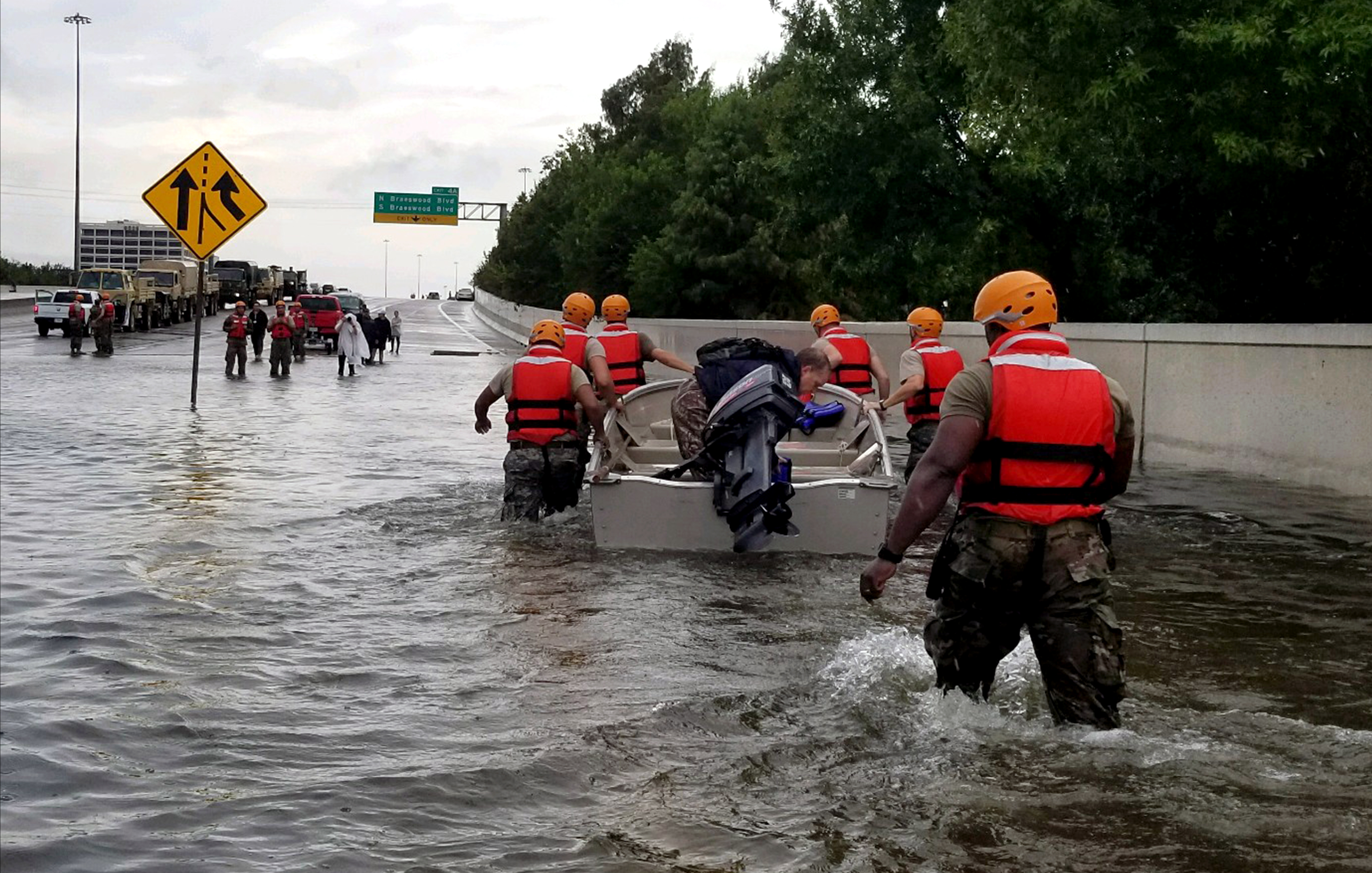 Soldiers with the Texas Army National Guard move through flooded Houston streets as floodwaters from Hurricane Harvey continue to rise, Monday, August 28, 2017. More than 12,000 members of the Texas National Guard have been called out to support local authorities in response to the storm. (U.S. Army photo by 1st Lt. Zachary West)